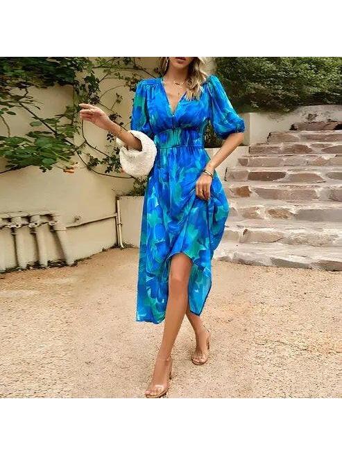 Blue Leona elegant midi dress by Lumina Vancouver, perfect for wedding guests, showcases a stylish, flowing design.