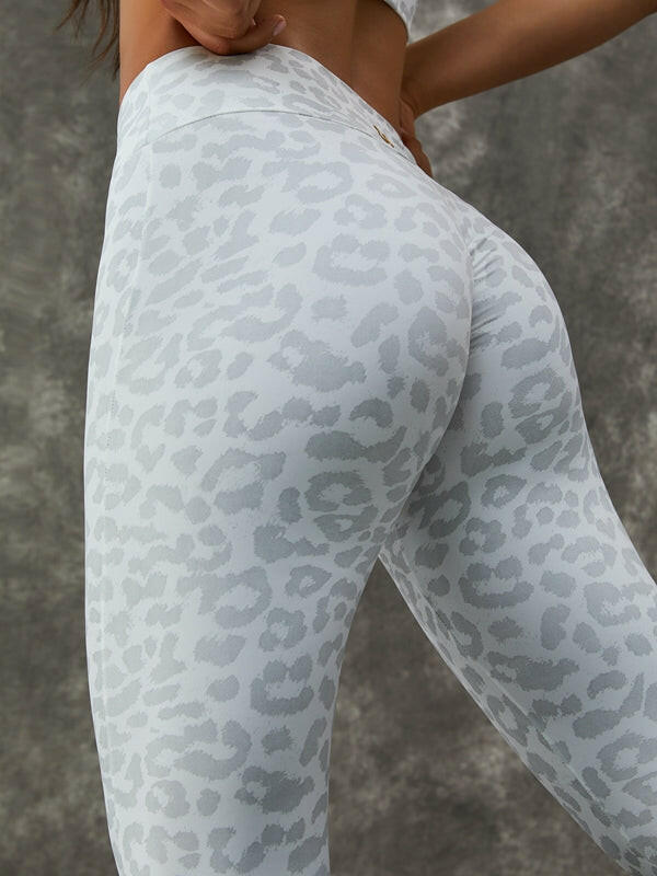 Leopard print Lumina Vancouver sports bra with zipper, stand collar, and white color, paired with matching leggings.