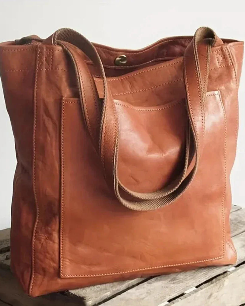 Chestnut brown Lumina Lila elegant versatile city handbag with smart storage, featuring sleek design and multiple compartments.