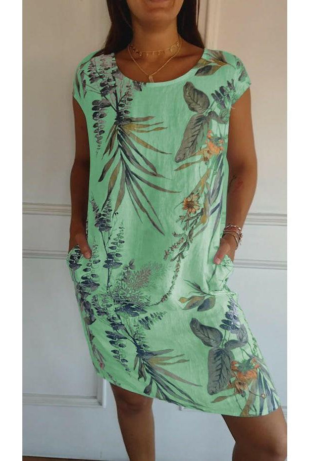 Lillian casual printed dress by Lumina Wear, white with colorful floral pattern, sleeveless, lightweight fabric for warm weather.