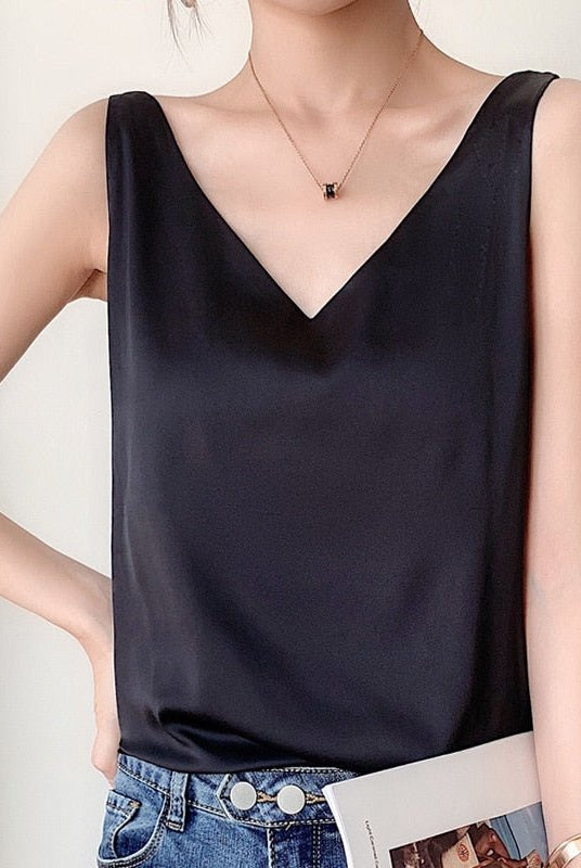 Black Lumina Wear Lily satin tank top with relaxed fit and V-neck, shown on a model. Comfortable and stylish camisole for casual wear.