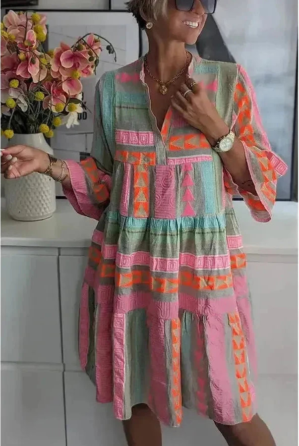 Lumina Wear Tuulikki spring dress in light fabric with floral pattern, short sleeves, and a fitted waist, perfect for warm weather.