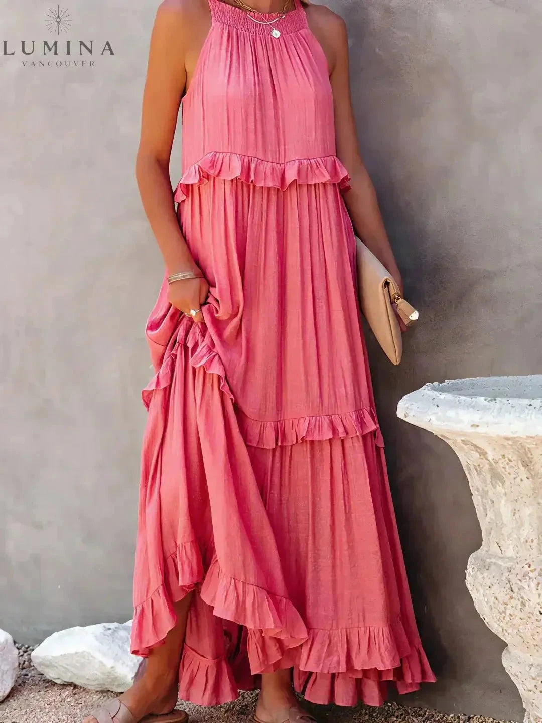 Apricot Lorena halterneck dress with ruffles and pockets by Lumina Wear, perfect for holiday vibes, shown on a model.