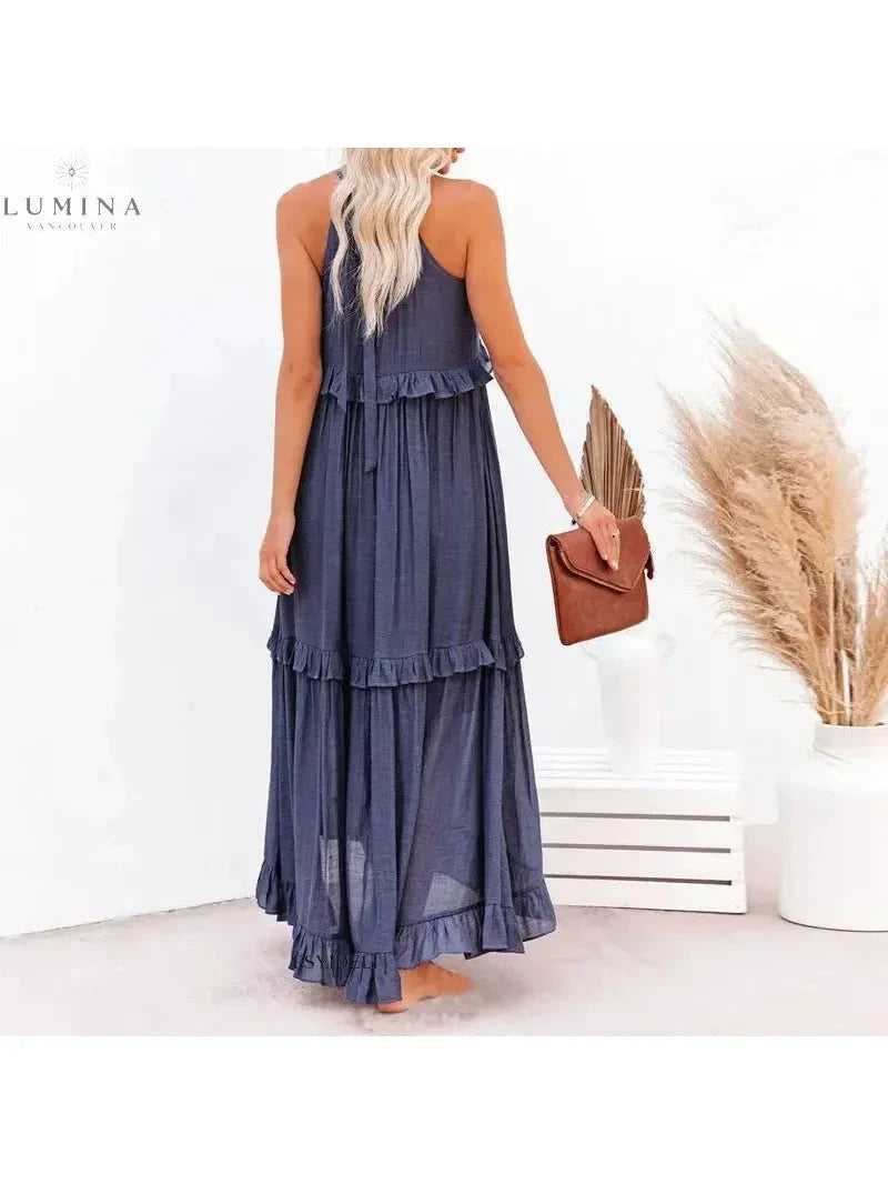 Apricot Lorena halterneck dress with ruffles and pockets by Lumina Wear, perfect for holiday vibes, shown on a model.
