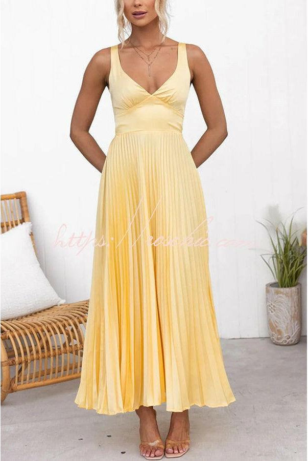 Yellow pleated dress by Lumina Vancouver, featuring a stylish and elegant design, perfect for special occasions.