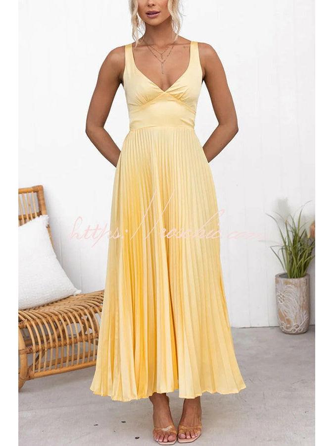 Yellow pleated dress by Lumina Vancouver, featuring a stylish and elegant design, perfect for special occasions.