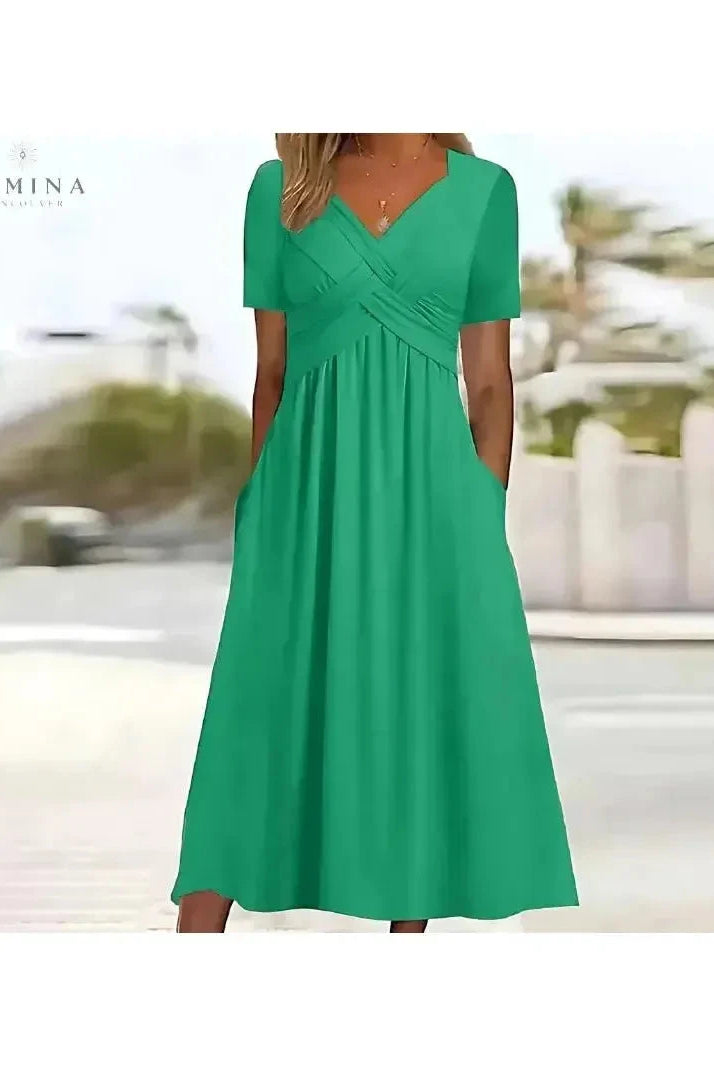 Lumina Wear Leila green elegant dress with tummy coverage, stylish and comfortable for special occasions, shown on a model.