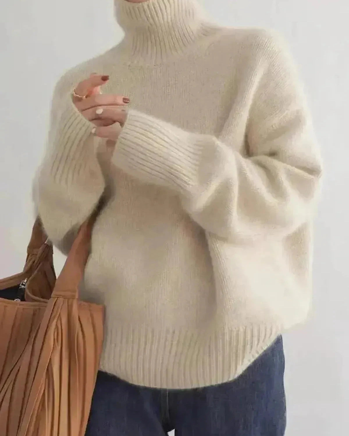 Beige Lena turtleneck sweater by Lumina Wear, made of soft knit fabric, displayed on a hanger.
