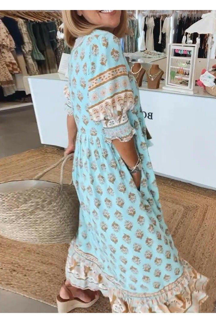 Lumina Wear Estrella casual half-sleeve blue maxi dress displayed on a hanger with a flowing fabric design.