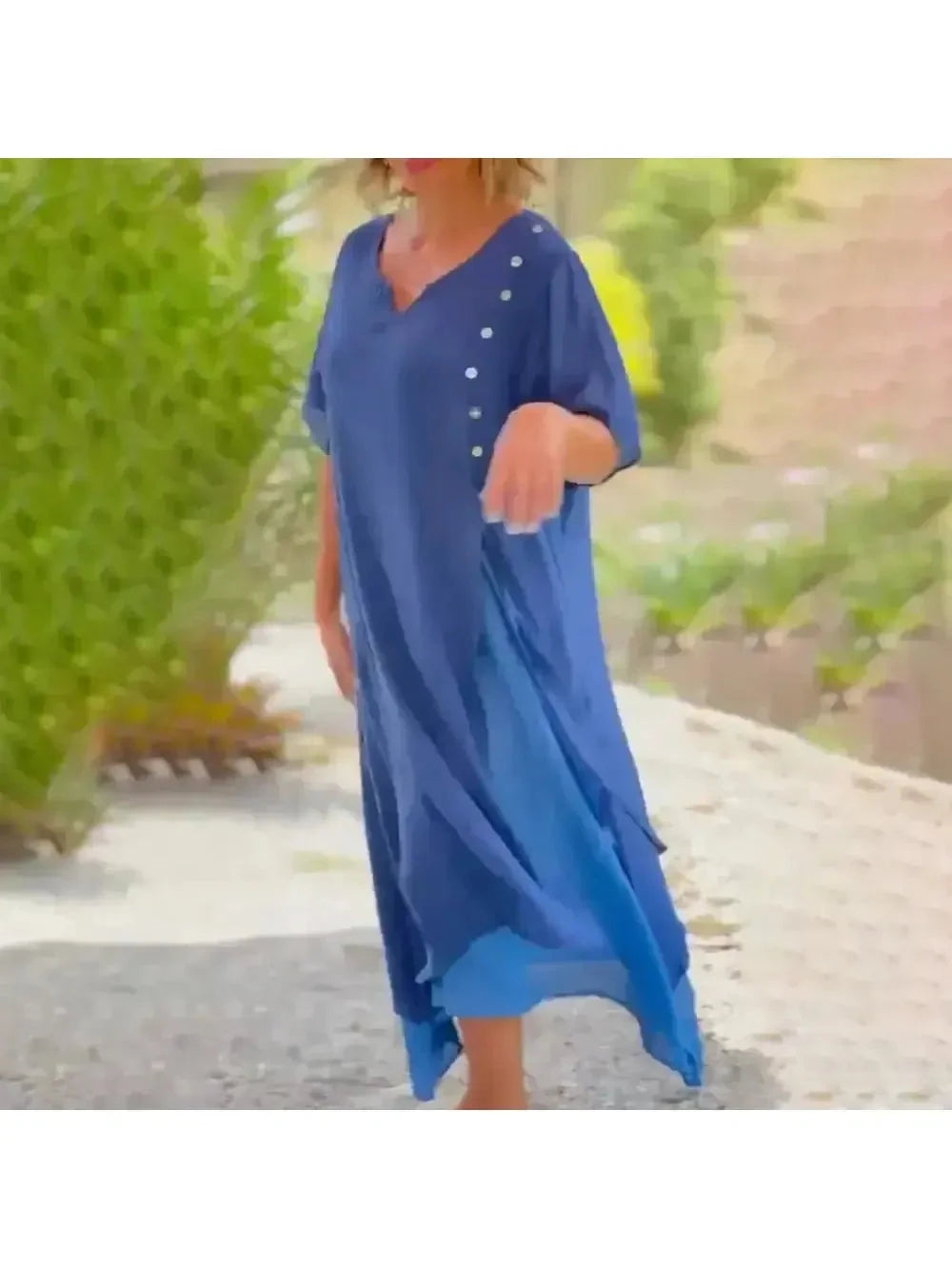 Blue Lumina Vancouver Rosalie classic solid color maxi dress displayed on a hanger with flowing fabric and simple design.