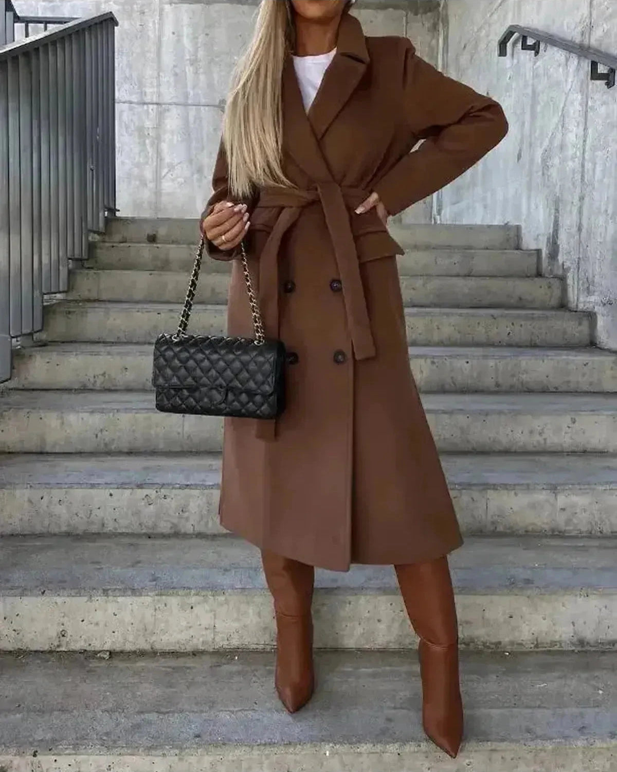 Beige Lumina Wear Kim double-breasted wool coat with elegant tailored design, shown hanging on a wooden background.