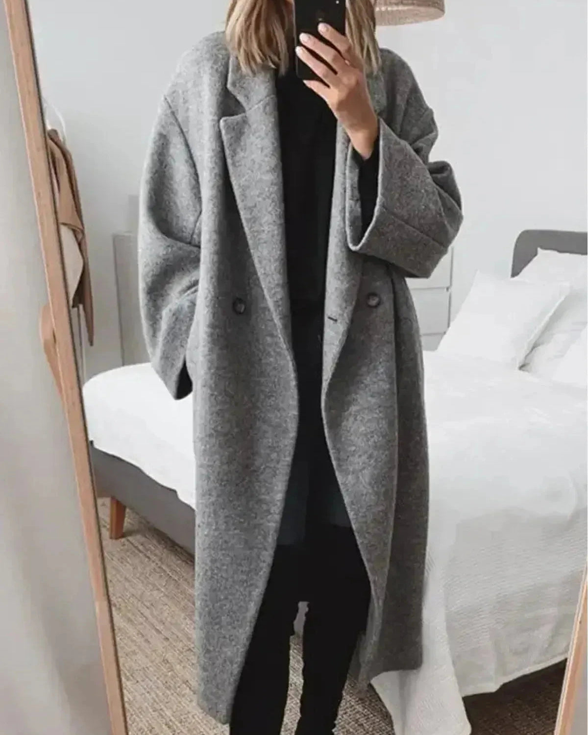 Grey Lumina Wear Kelly women's winter long coat hanging on a rack, showcasing its classic tailored design and cozy fabric.