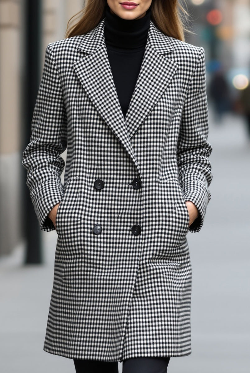 Black Enid Lumina Vancouver double-breasted checked wool coat displayed on a hanger, showcasing classic pattern and tailored fit.