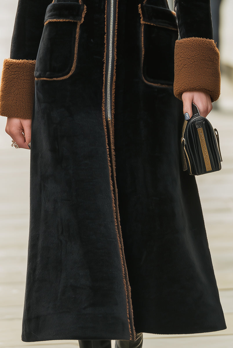 Black Lumina Vancouver Beatrix long plush coat with elegant contrast trim, shown on a model with a stylish, cozy look.