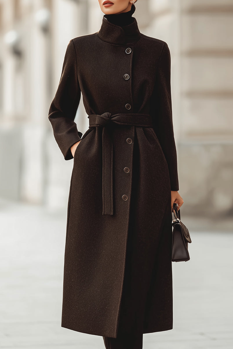 Brown Lumina Vancouver Georgie belted wool blend maxi coat hanging on a wooden hanger, showcasing its length and tailored fit.