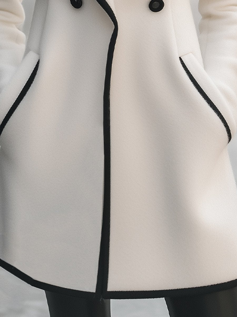Lumina Vancouver double-breasted white coat with black trim, stylish coat for women, shown on a model.