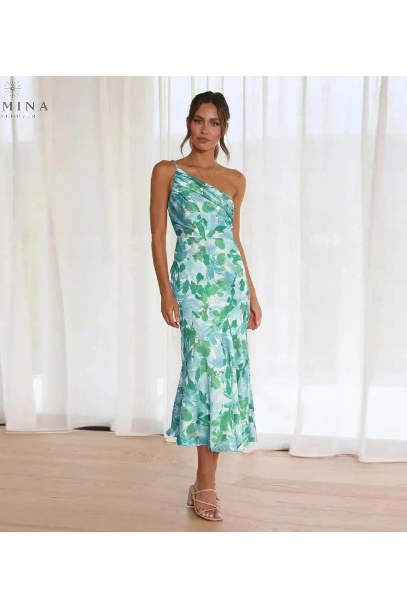 Lumina Wear Tiphaine dress with vibrant orange floral pattern, short sleeves, and flowing silhouette, perfect for warm weather.