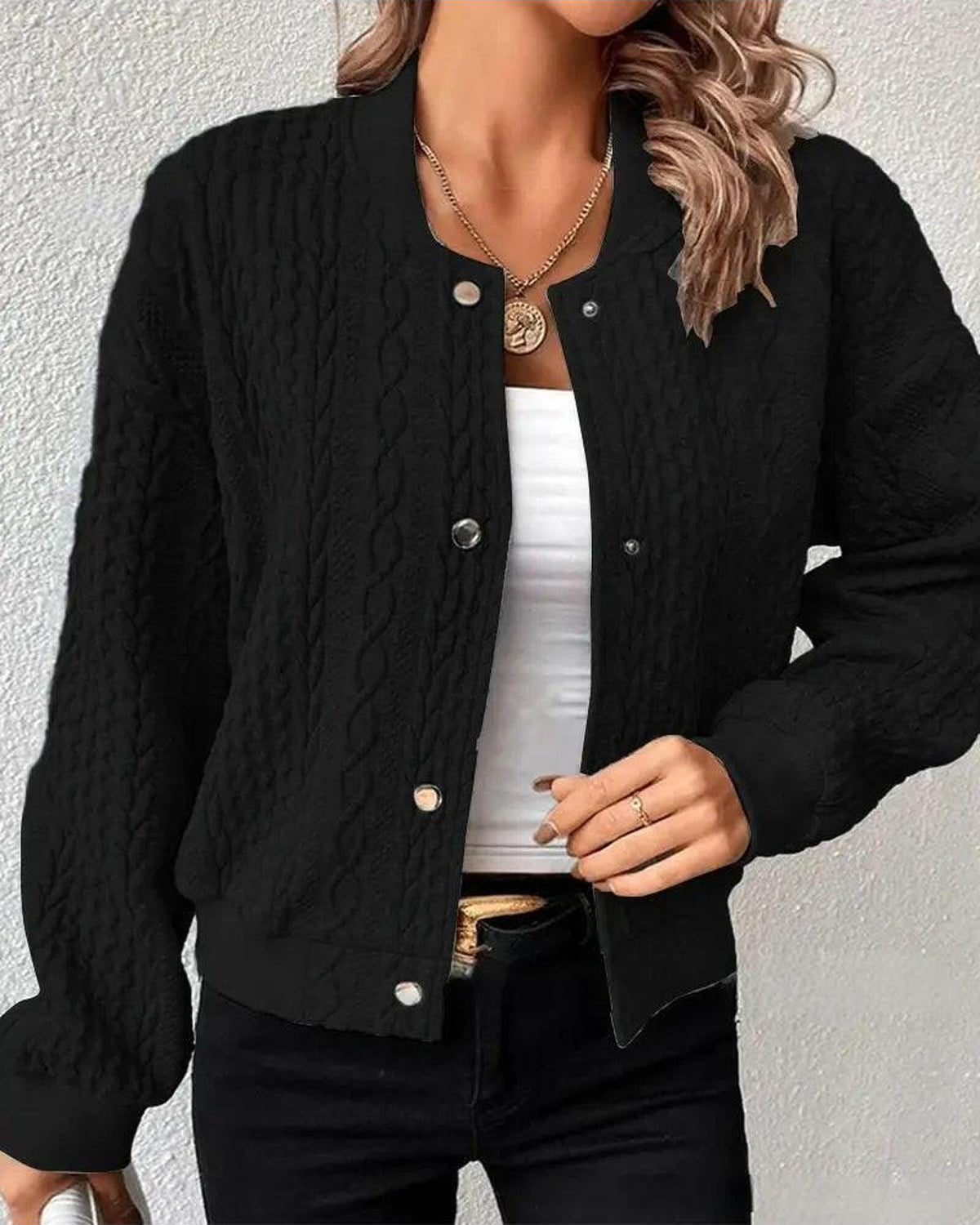 Light grey Amaia cardigan by Lumina Wear, shown on a hanger with a cozy knit texture and button details.