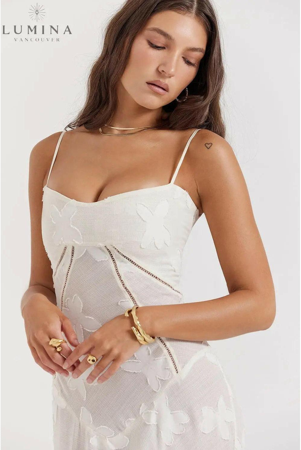 White Mireille romantic summer dress by Lumina Wear, featuring lightweight fabric and a flowing silhouette perfect for warm weather.