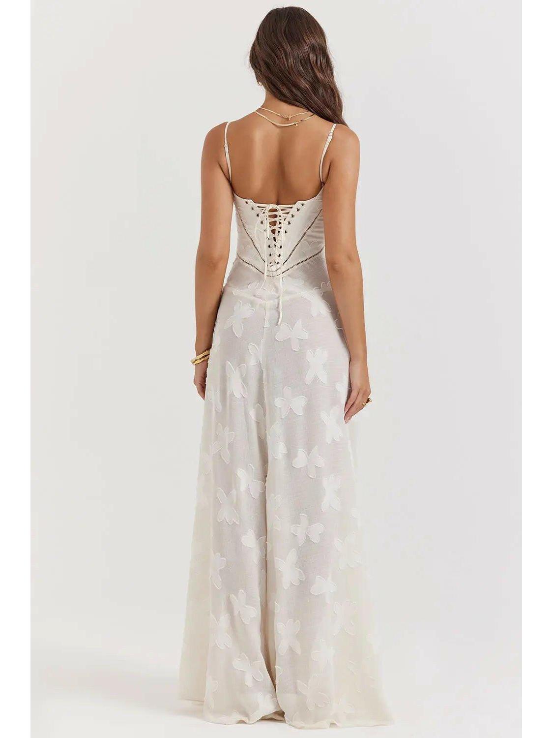 White Mireille Romantic Summer Dress by Lumina Vancouver, perfect for holiday vibes, shown on a woman in a beach setting.