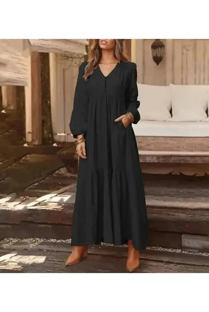 Light yellow Lumina Vancouver Giulia long sleeve dress displayed on a hanger, showcasing its elegant design and fabric details.