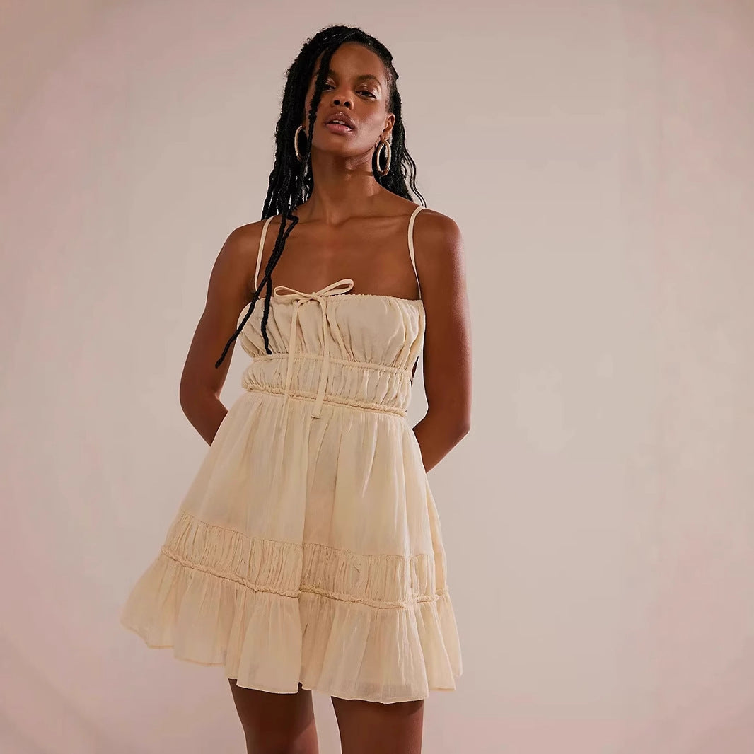 Lumina Vancouver Valence mini dress in apricot with smocked bust and strap details, showcasing a stylish and fitted design.