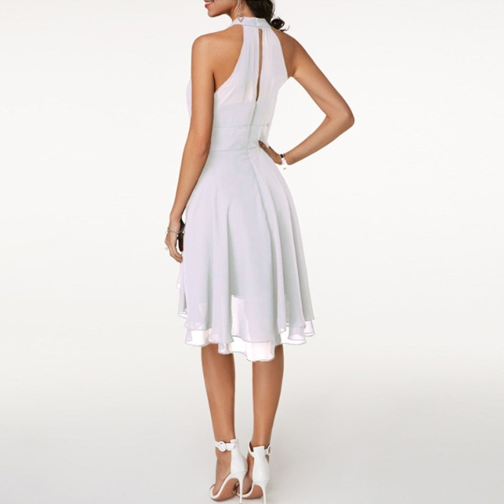Black Lyra halter neck mini dress with layered skirt from Lumina Vancouver, styled for a chic, modern look.