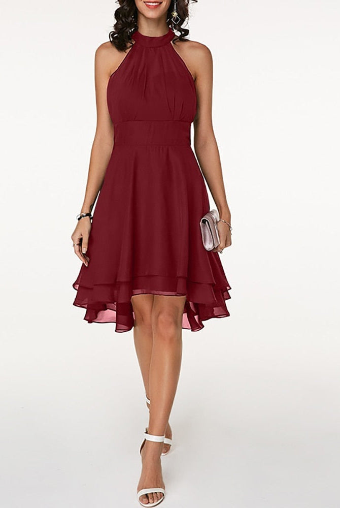 Black Lyra halter neck mini dress with layered skirt by Lumina Vancouver, shown on a model with a sleek, stylish look.