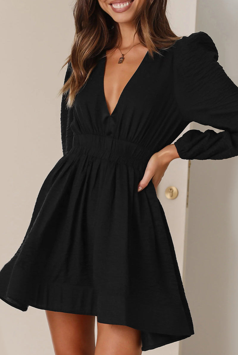 Black Lumina Vancouver Nova mini dress with v-neckline and puff sleeves, showcased on a model.