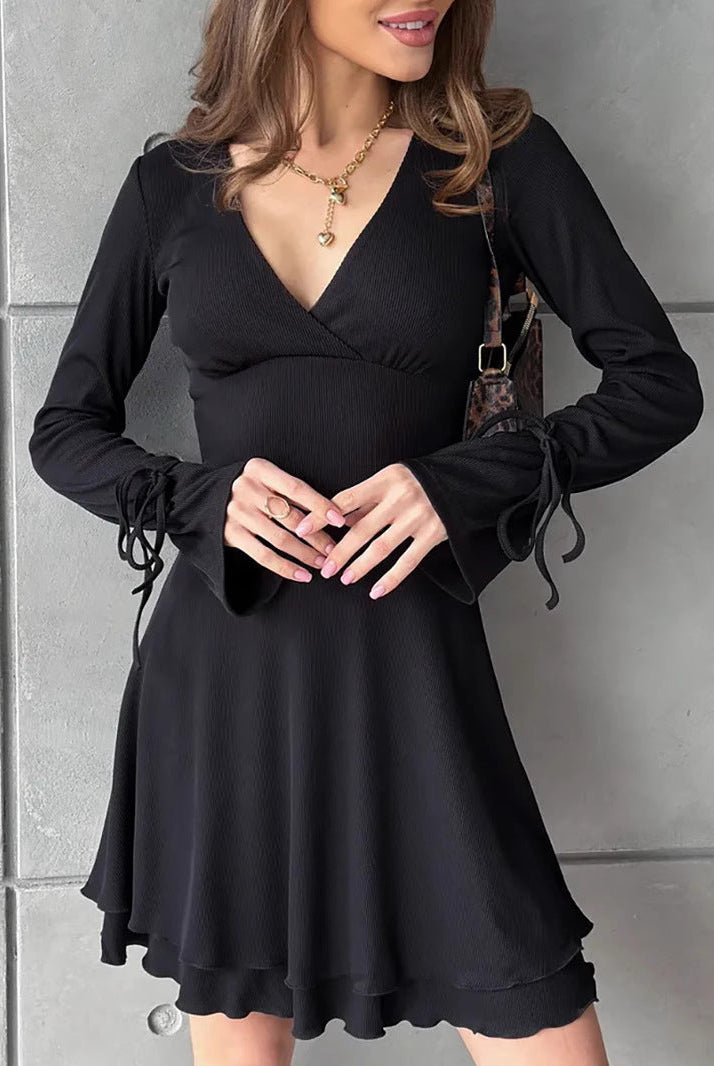 Black Gwyneth mini dress by Lumina Wear featuring flared sleeves and a deep V-neck, displayed on a mannequin.