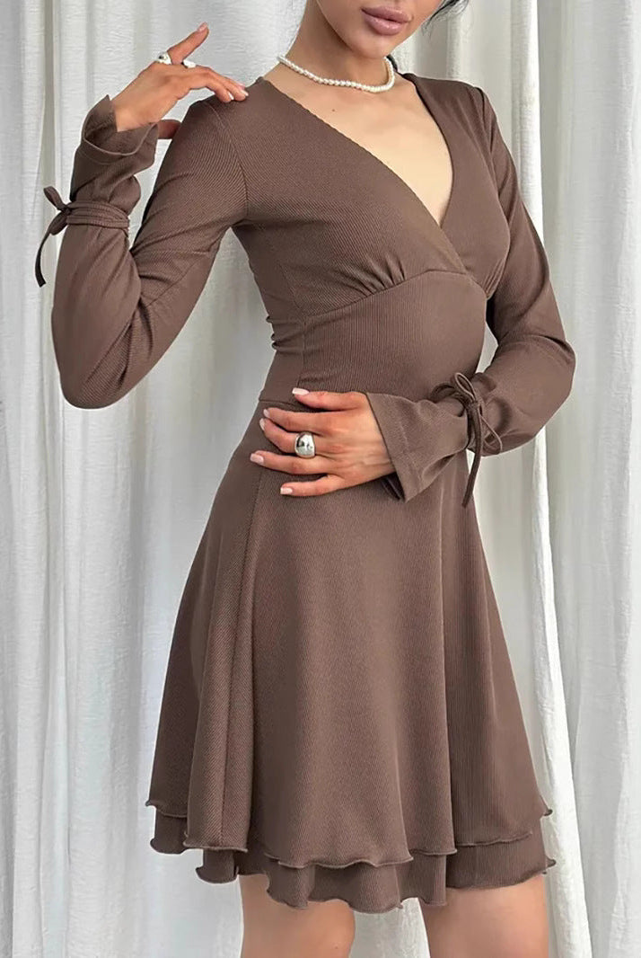 Black Gwyneth mini dress with flared sleeves and deep V-neck by Lumina Vancouver, shown on a model.