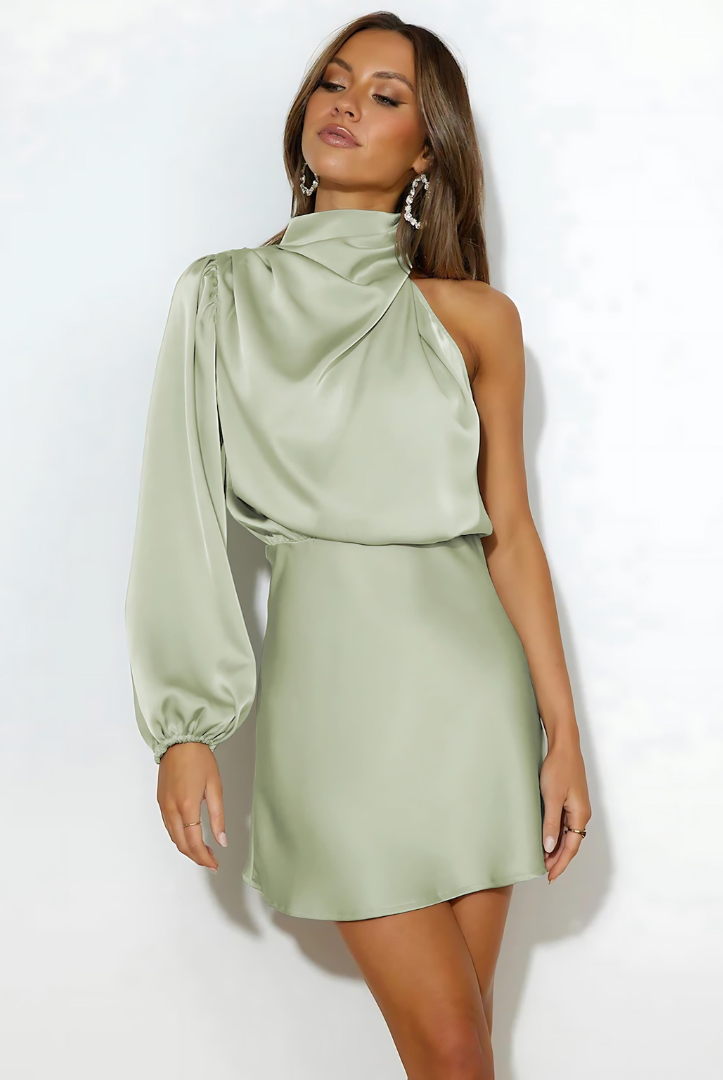 Black Nova one-shoulder mini dress with satin finish by Lumina Wear, shown on a model with sleek styling.