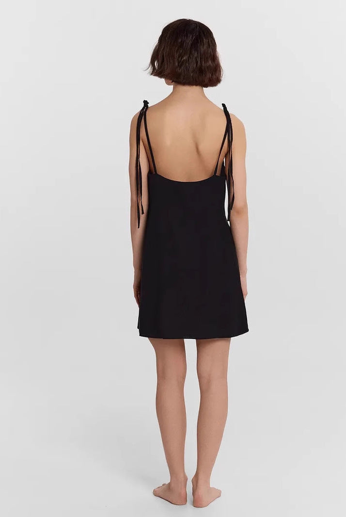 Black Carys Satin Slip Dress by Lumina Wear, a sleek mini slip dress with smooth satin fabric and subtle shoulder straps.