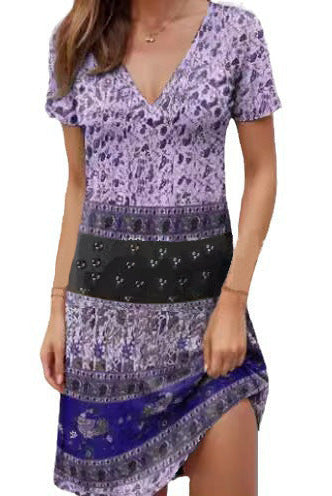 Green Kira mini dress by Lumina Vancouver featuring relaxed fit and patchwork boho style, shown on a hanger.