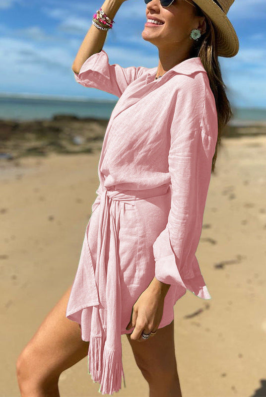Pink Lumina Wear Tuuli Cotton Linen Wrap Mini Dress with a fitted waist and short sleeves, styled for casual wear.