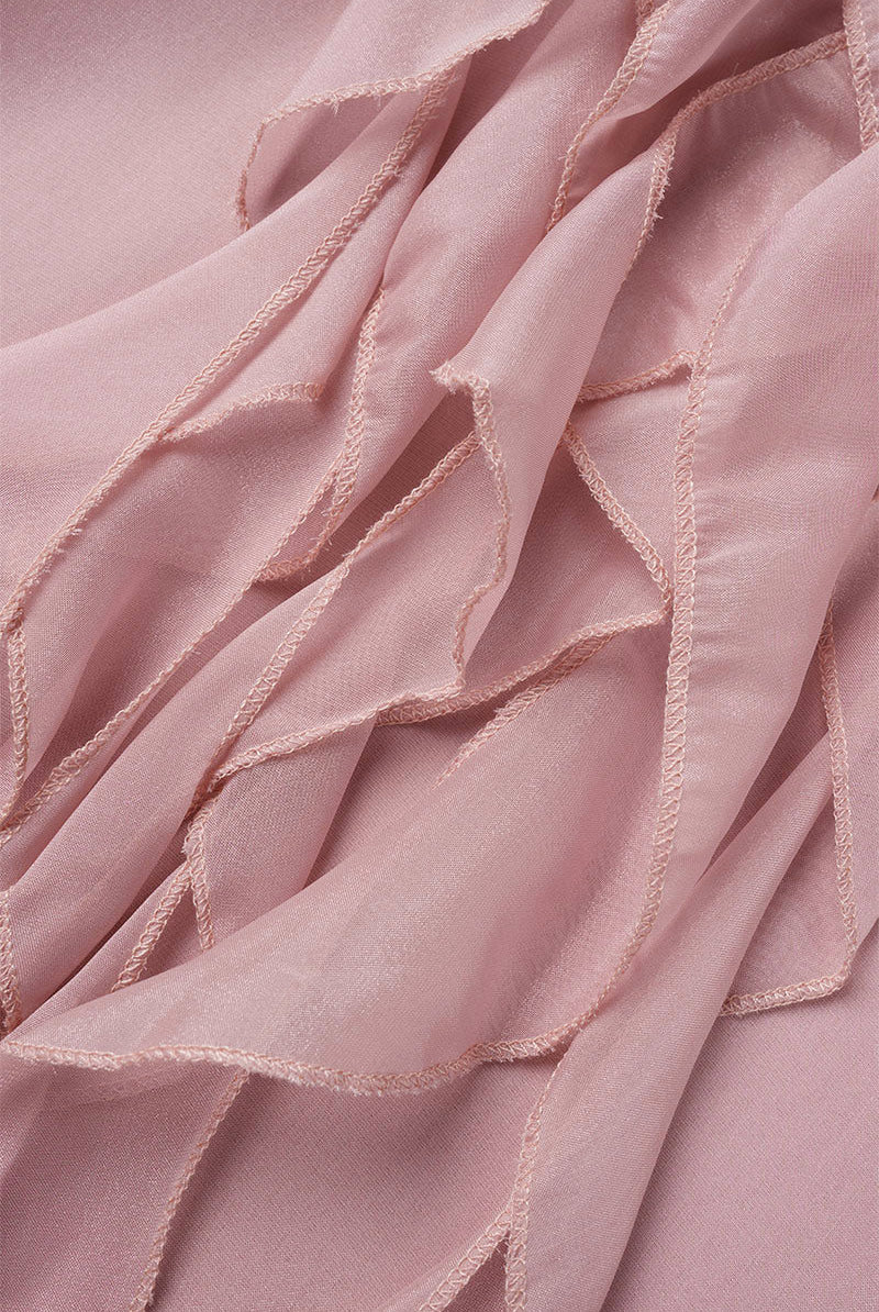 Pink knee-length flowy mini dress with V-neck from Lumina Wear's Paivi collection, displayed on a model.