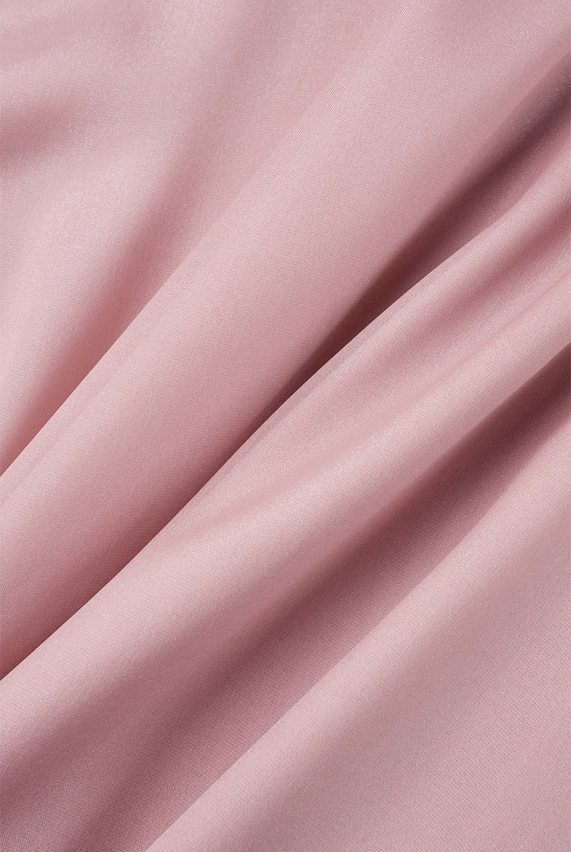 Pink Lumina Wear knee-length flowy mini dress with V-neck and long sleeves, shown on a model, perfect for casual or semi-formal wear.