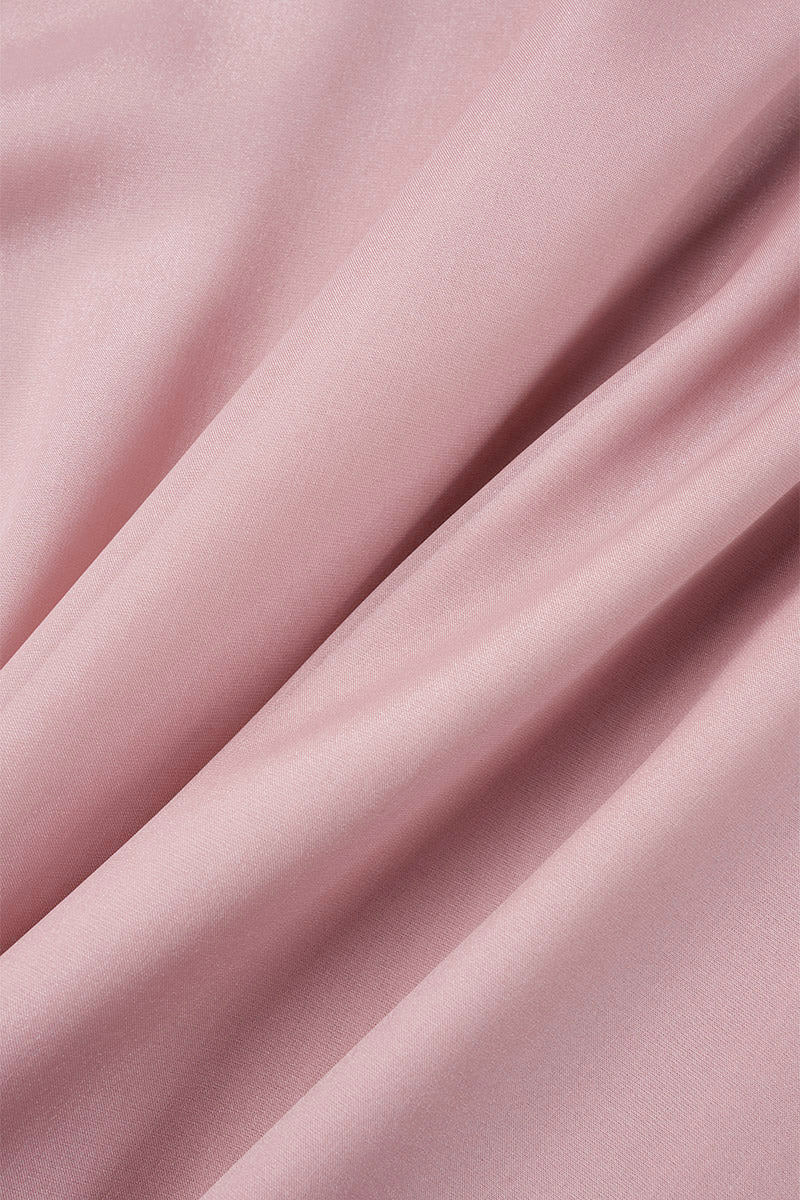 Pink knee-length flowy mini dress with V-neck by Lumina Vancouver, featuring a relaxed fit and lightweight fabric.