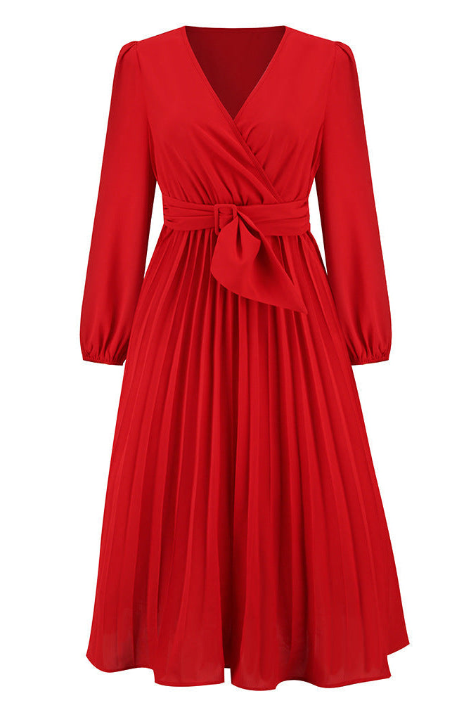 Pink Nova long-sleeved V-neck pleated mini dress by Lumina Wear, shown on a model with a fitted waist and flowing skirt.