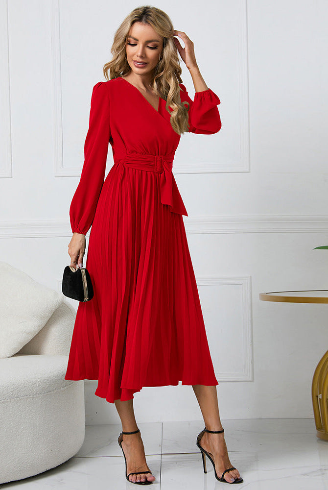 Pink Nova long-sleeved V-neck pleated mini dress from Lumina Vancouver, shown on a hanger with fabric details visible.