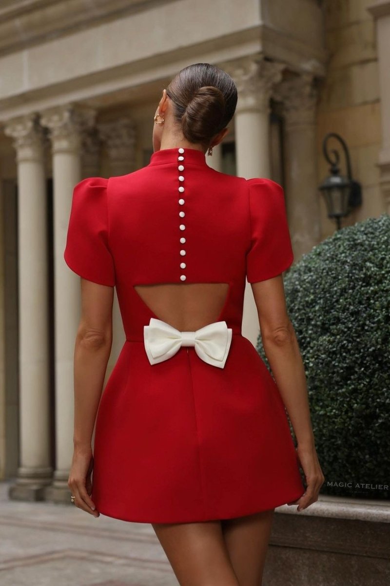 Red Lumina Vancouver Nova mini dress with tailored fit, open back, and bow detail, perfect for stylish evening wear.