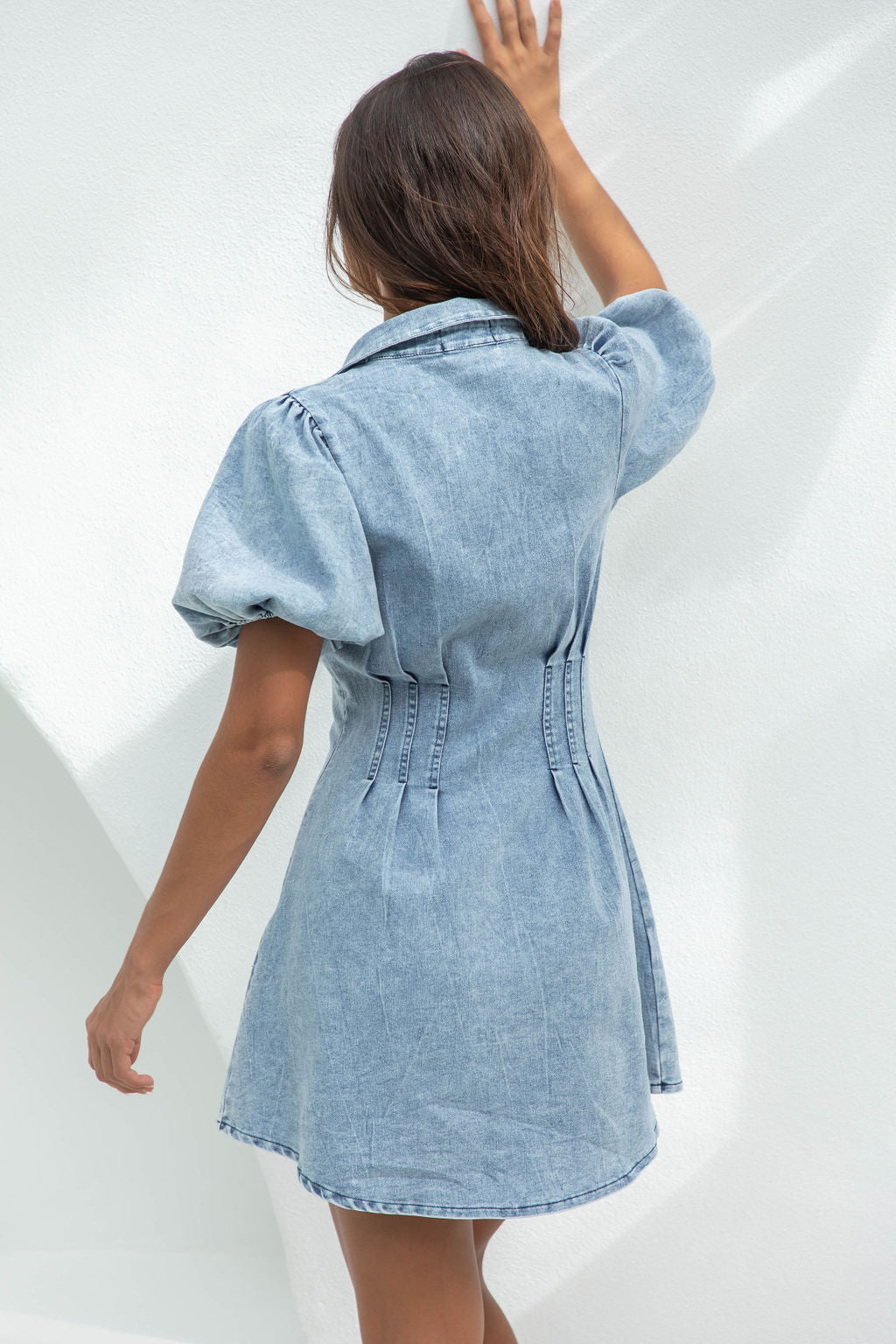 Lumina Vancouver Nova denim mini dress with button-down front, sleeveless style, and fitted silhouette.