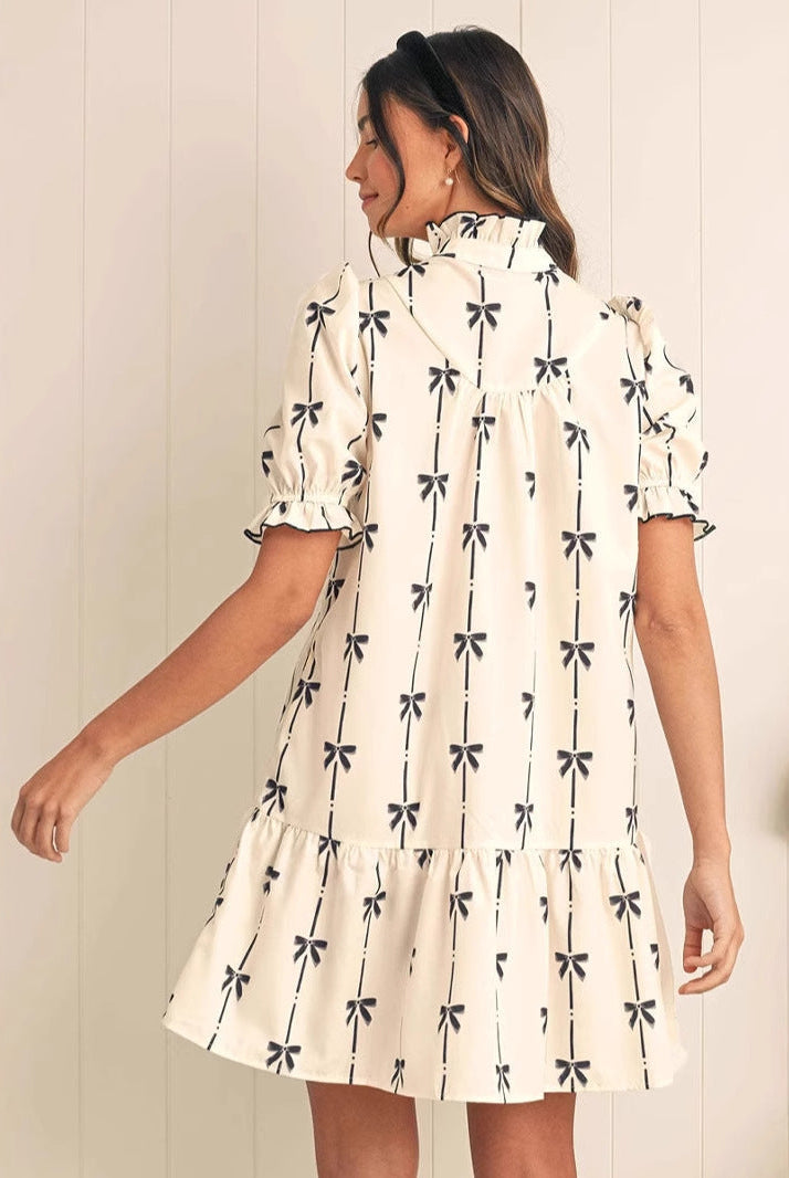 White Elara Cotton Bow Daydream A-Line Mini Dress by Lumina Vancouver, featuring a bow detail and elegant fit.