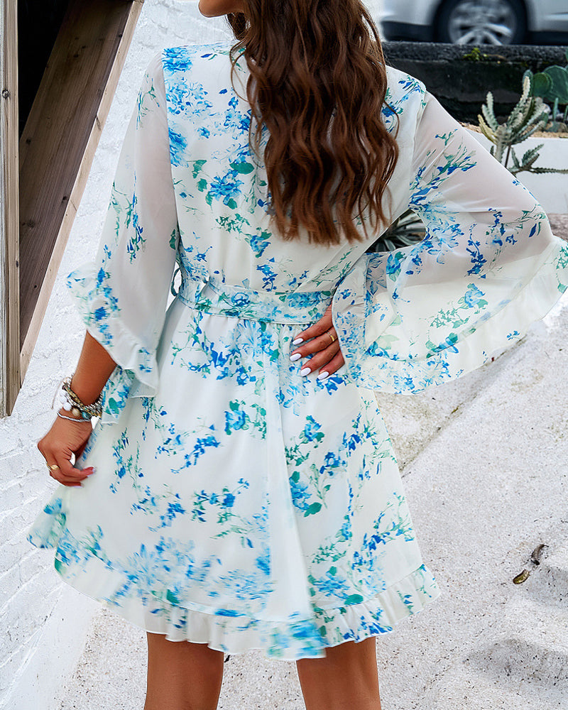 White women's floral V-neck mini dress by Lumina Vancouver, featuring a stylish and feminine design, perfect for casual or semi-formal wear.