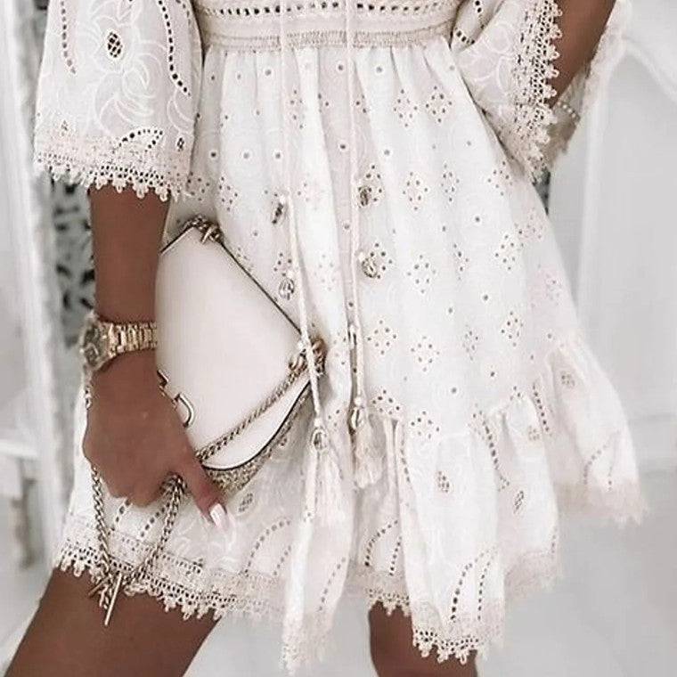 White Isadora Moonlight Muse V-neck mini dress by Lumina Vancouver, showcasing a stylish, elegant design with a flowy silhouette.