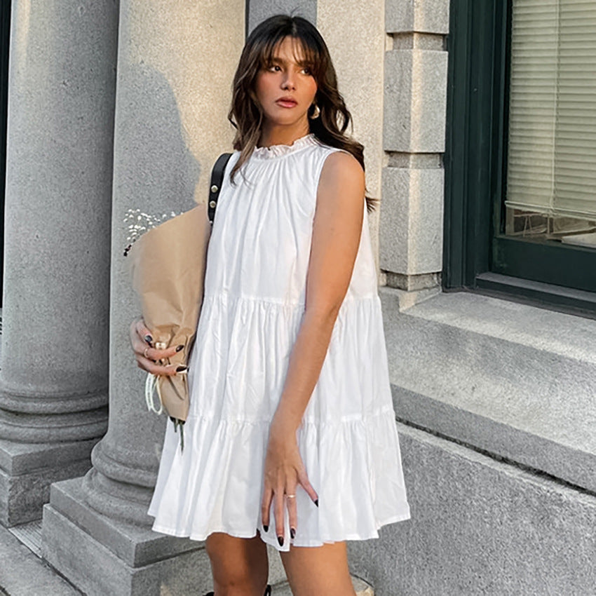 White Nova Breeze sleeveless A-line mini dress by Lumina Vancouver, shown on a model with a casual summer look.