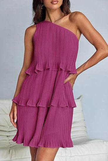 White Nova pleated one-shoulder mini dress by Lumina Vancouver, featuring elegant gathered fabric and stylish asymmetrical design.