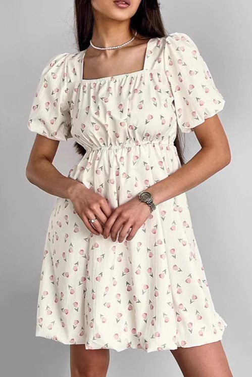 Seraphina floral mini A-line dress by Lumina Vancouver, white with colorful flower pattern, stylish and lightweight for warm weather.