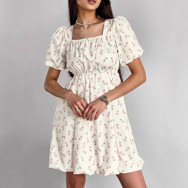 Seraphina floral mini A-line dress by Lumina Vancouver, white with colorful flower pattern, stylish and lightweight for warm weather.