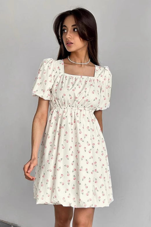 Seraphina floral mini A-line dress by Lumina Vancouver, white with colorful flower print, lightweight and stylish for summer wear.